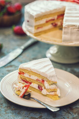 Freshly made strawberry cake on the rustic background	