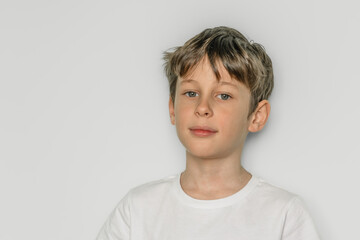 Confident boy. Portrait of a white caucasian 9 year old boy in a white t-shirt. copy space