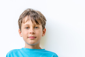 Portrait of a handsome white Eastern European 9 year old boy. The child looks directly into the...