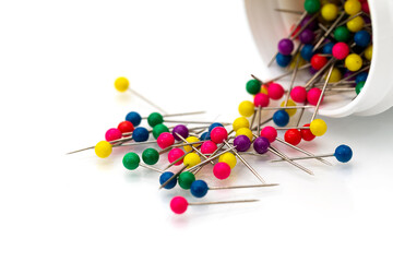 Map push pin needles fall out from white jar isolated white background.