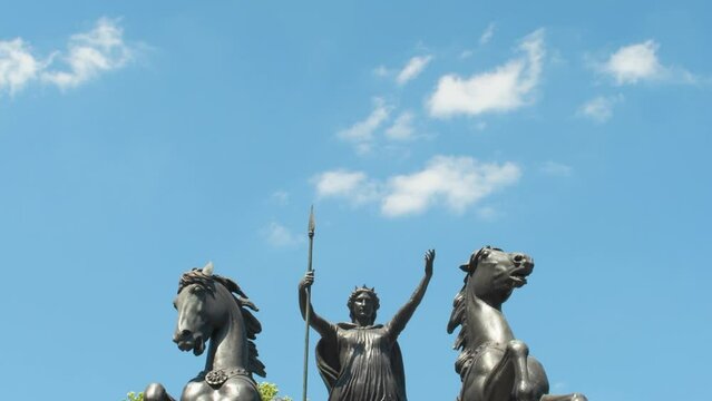 4k footage of the statue Boadicea and Her Daughters in Westminster, London, England, depicting queen Boudicca holding a spear while riding in a chariot, with vertical tilt panning