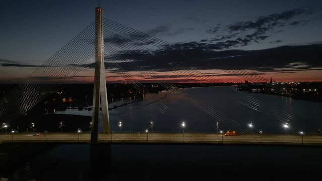 Aerial panoramic view of the Riga bridge across river Daugava at night. Cable-stayed bridge in Riga, Latvia at night.