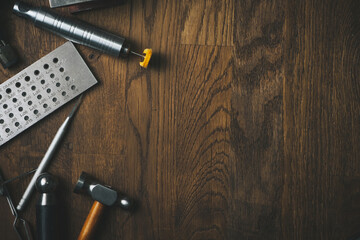Desktop for craft jewellery making with professional tools. Vintage jeweler tools on wooden table....