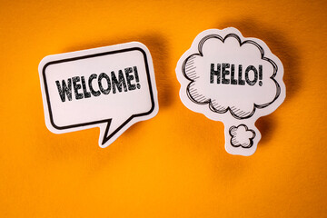 Welcome. Speech bubbles with text on an orange background © STOATPHOTO