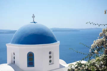 Fotobehang Santorini blue dome of white church in Oia with sea view and volcano, Greece landmark © axynia