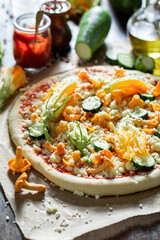 Preparations for tasty pizza made of fresh and summer vegetables.