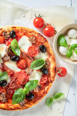 Fresh and crunchy pizza Capricciosa with prosciutto, mushrooms and cheese.