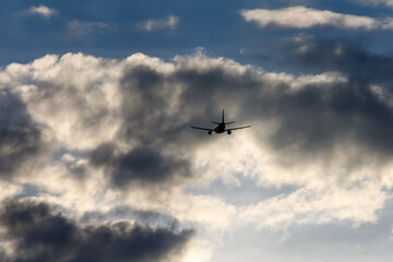 Airplane in the cloudy sky.