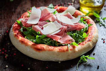 Homemade pizza Parma with parma ham and parmesan cheese.