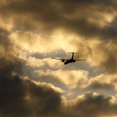 Airplane in the cloudy sky.