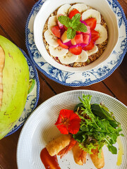 Healthy Delicious Breakfast Including Smoothie Bowl With Fruits And Berries And Asian Spring Rolls With Flower Decoration