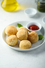 Traditional homemade arancini balls with tomato sauce