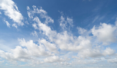 Fototapeta premium Clear blue sky with white fluffy clouds. Nature background.