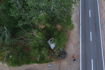 Severe accident. Traffic accidents on the road. View from above. The car got into an accident. Traffic jam. Truck without trailer crashed into a tree