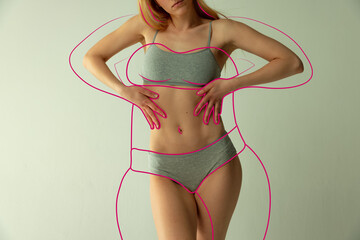 Cropped slim female body with pink lines around body symbolizing bigger body shape isolated over...