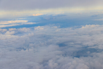 Naklejka na ściany i meble Beautiful white clouds in blue sky. View from airplane