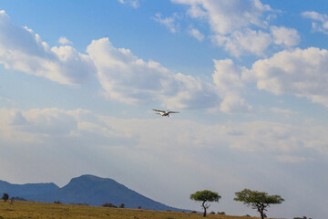 Airplane flying over the african savanna in Serengeti national park, Tanzania