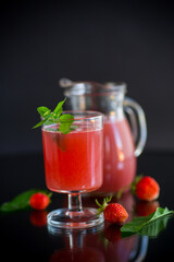Cold summer strawberry kvass with mint in a glass