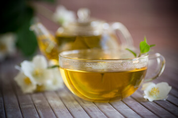 Composition with cup of jasmine tea and flowers