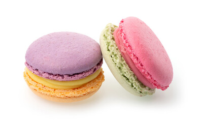 Violet orange and rose green macarons on isolated white background