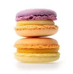 Violet orange and orange yellow macarons with yellow filling on isolated white background one on the other, side view
