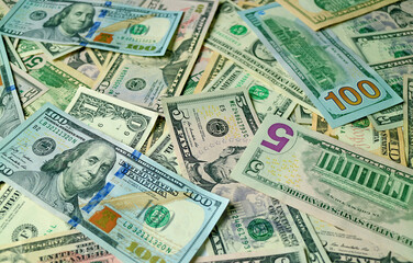 Fototapeta na wymiar Closeup heap of United States dollar bills for the concept of business and wealth