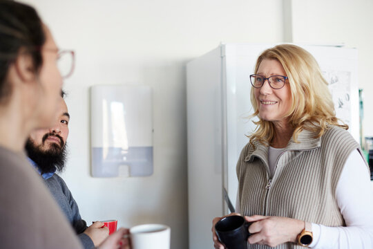 Co-workers talking during coffee break