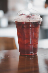 Iced raspberries and blackberries in take away glass