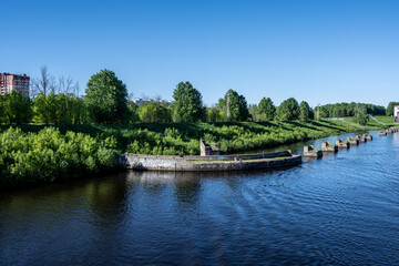 river boat passes through the lock on the river on a summer day