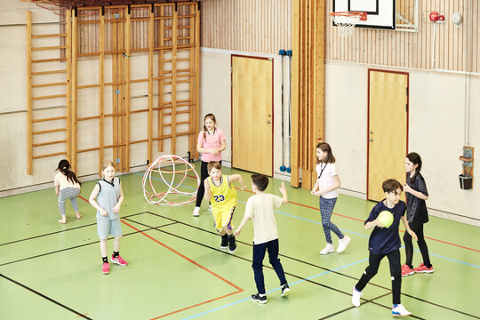 Children having PE class in school gym