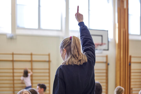 Teacher raising hand during PE class