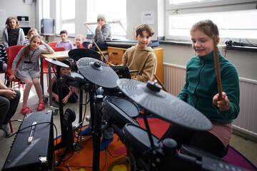 Children playing drums at school