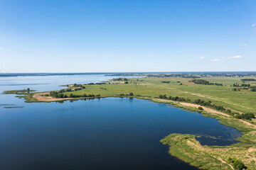 View from the drone over the lake and thickets, lake landscape.