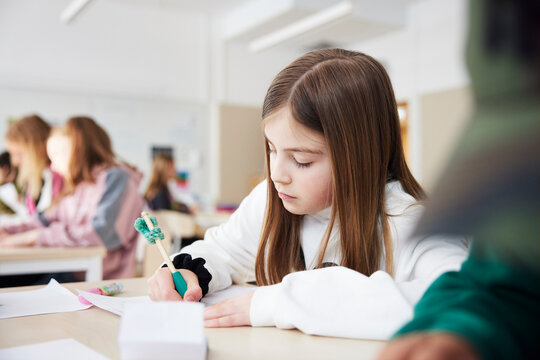 Girl doing writing assignment at school