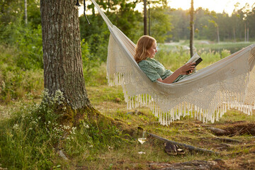 Woman reading book on hammock