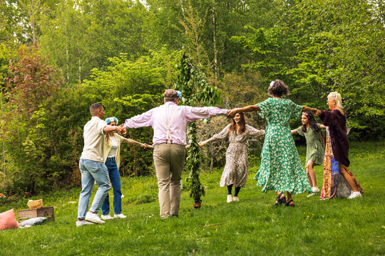 People dancing around midsummer maypole