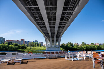 modern metal bridge over a large river on a sunny day