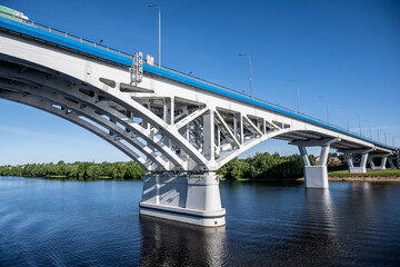 modern metal bridge over a large river on a sunny day