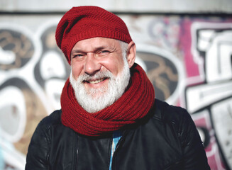 Cheerful pensioner wearing red hat stock photo