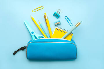 Top view of pencil case with school supplies. Back to school concept - obrazy, fototapety, plakaty