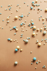 Colorful round candy dragees on a spicy background. Conditre decor and sprinkles for desserts. Creative background with sweets