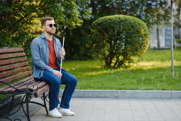 blind man sitting on a bench