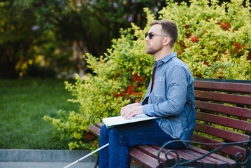 blind man sitting on a bench