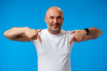 Fototapeta premium Handsome middle age mature man pointing to copy space