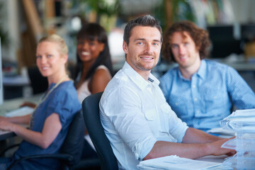 We put hardwork into everything we do. Cropped shot of four businesspeople sitting in the office.