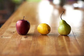 red apple, lemon and green pear.  fruits on the wooden table with reflection. Vitamins