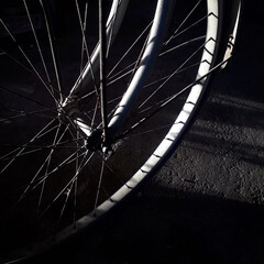 close up of bicycle wheel on black