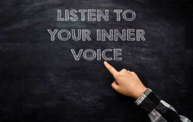 Coach points to Listen to your Inner Voice on chalkboard