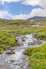 Fototapeta na wymiar Mountain stream landscape view with a mountain peak