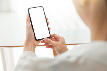 cell phone blank white screen mockup.hand holding texting using mobile on desk at office.background empty space for advertise.work people contact marketing business,technology